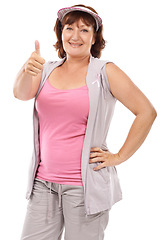 Image showing Mature woman portrait, breast cancer ribbon and thumbs up for awareness, disease recovery fitness or support agreement. Emoji like icon, survivor feedback or model studio campaign on white background