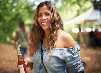 Image showing Portrait of woman at music festival with smile, beer and relax in nature for concert event. Drink, celebration and girl at outdoor party for freedom, adventure and happy people in park, forest or sun