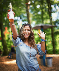 Image showing Portrait of woman at music festival with dance, beer and smile in woods at concert event. Alcohol, celebration and girl at outdoor party in freedom, adventure and person in park, forest and happiness