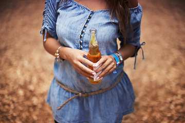 Image showing Hands of woman at music festival with nature, beer and relax in woods for concert event. Alcohol, celebration and girl at outdoor party in freedom, adventure and person in park, forest or countryside