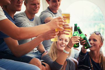 Image showing Group of friends at music festival with drinks, cheers and concert fans relax together event. Beer toast, men and women at fun celebration, outdoor party or summer adventure with happy people in tent
