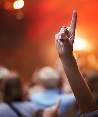 Image showing Closeup, hand and person with music festival, cheering and concert with blur background, party and group. Finger, fan and sign with gesture, event and crowd with praise, celebration and performance