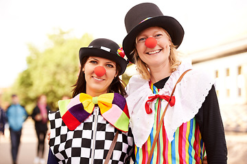 Image showing Clown, people and portrait outdoor at festival, carnival or costume for event or concert in park. Happy, women and smile in funny props, clothes and dress up for culture, party in summer or holiday