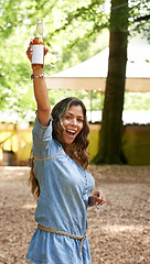 Image showing Portrait, excitement and hand up with a woman at a music festival, drinking beer in celebration. Freedom, energy and shouting with a happy young person outdoor at a concert, show or performance