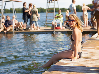 Image showing Summer, bikini and woman at lake to relax, party and people on dam, deck with water. Happy, holiday and portrait of vacation with girl in swimwear or fashion on wood, dock and sitting in sunshine