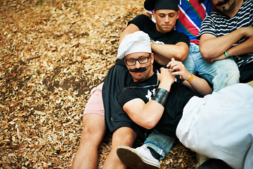 Image showing Music festival, friends in costume and event with a group of young people on the ground outdoor from above. Party, summer and men lying on the ground at a show, concert or event at a summer venue