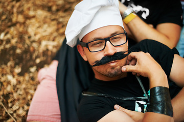 Image showing Face, thinking and a man in a chef costume outdoor at a music festival for celebration or performance. Idea, relax or funny and a young person at a carnival for an event or show with his friends