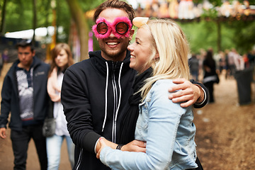 Image showing Happy couple, hug and music festival for love, care or support at crowded party, DJ event or fun park. Man and woman smile in embrace, affection or trust for festive outdoor celebration or holiday