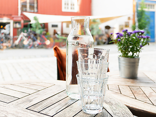 Image showing Three glasses and a carafe with water