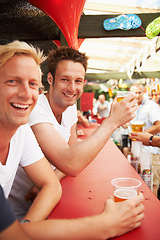 Image showing Happy man, friends and drinking at music festival, bar or event for summer party or DJ concert. Portrait of male person smile with alcohol or beer for friendship at carnival or outdoor cafe stand