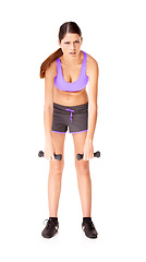 Image showing Portrait, dumbbells and woman with fitness, tired and workout isolated on a white studio background. Person, girl and model with gym equipment, fatigue and wellness with exercise, exhausted or health