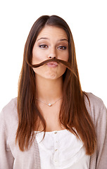 Image showing Funny, woman and portrait with hair as a mustache in studio, white background or model with confidence. Person, pouting and posing with hairstyle, beauty or silly girl with crazy expression or face