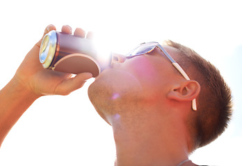 Image showing Man, drinking and beer with sunlight outdoor for concert, event or music festival with sunglasses and lens flare. Person, alcohol and beverage in summer for relax, freedom and enjoyment with sunshine