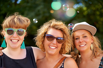 Image showing Portrait, outdoor and women with party, concert and social event with music festival, happiness and summer. Face, people and friends with lens flare, sunshine and weekend break with joy and smile