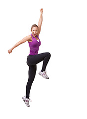 Image showing Woman, cheers and jump in studio for fitness, workout and training celebration, energy or achievement. Excited portrait of sports model or runner stretching in air with success on a white background