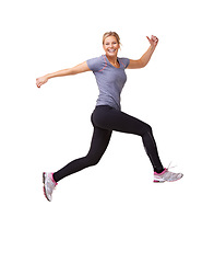 Image showing Woman, running and jump in studio for fitness, workout and training celebration, energy or achievement. Excited portrait of sports model or runner in air for exercise and cardio on a white background