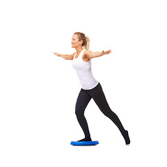 Image showing Balance, health and smile with woman on disk in studio for workout, mindfulness or exercise. Wellness, challenge and training with person on white background for flexibility, fitness or aerobics