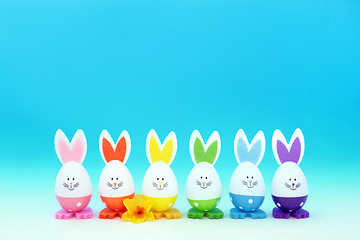 Image showing Easter Bunny Rainbow Eggs with Spring Narcissus Flower