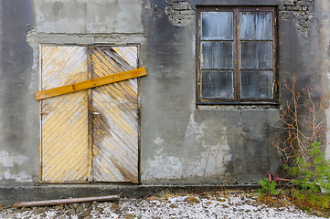 Image showing Boarded-Up Door and Weathered Window on an Abandoned Buildings G