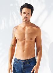 Image showing Portrait, man and shirtless with confidence with fashion mock up on white background in Greece. Male model, face and serious expression with person for cool, trendy and modern style with jeans