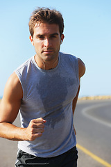 Image showing Sports, sweat and man athlete in mountain running for race, marathon or competition training. Fitness, workout and body of male runner doing a cardio exercise for health or wellness in outdoor nature