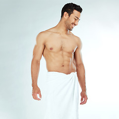 Image showing Shower, towel and happy fitness man in studio for wellness, hygiene or body care routine on white background. Cleaning, grooming or muscular Japanese male model with pamper, cosmetics or treatment