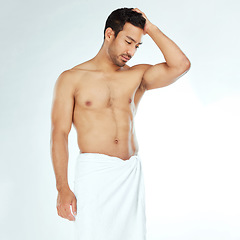 Image showing Towel, shower and fitness man thinking in studio for wellness, hygiene or body care routine on white background. Cleaning, grooming or muscular Japanese male model with pamper, cosmetics or treatment