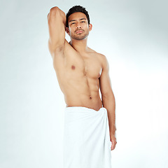 Image showing Shower, towel and portrait of asian man body in studio for wellness, cosmetics or cleaning on white background. Bathroom, face and Japanese male model with confidence, attitude or spa aesthetic pose