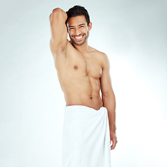 Image showing Portrait, body and happy asian man with a towel in studio for shower, wellness or cosmetics on white background. Bathroom, face and Japanese male model smile for luxury pamper, grooming or treatment