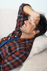 Image showing Happy, relax and man on sofa in home for afternoon nap, resting and sleeping in living room. Asleep, eyes closed and tired person on couch lying for fatigue, comfortable and wellness in apartment