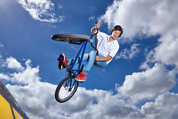 Image showing Trick, jump and man with bike in sky at park, event or competition for sport with risk, energy or freedom. Mockup, space or person in air with fearless stunt on bicycle for fun adventure in summer
