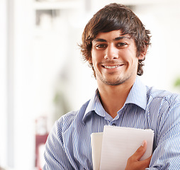 Image showing Businessman, portrait and happy with notebook in office, confident and career pride for startup. Entrepreneur, smile or face of creative writer for job ambition, planning or relax wellness in company