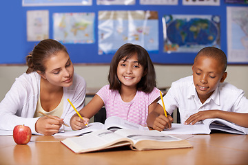 Image showing Teacher, girl and school kids in classroom, portrait and writing, learning together and development with studying. Woman, children and help with notebook for support, teaching or education with smile