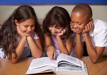 Image showing School kids, reading and happy in classroom with book, pointing and thinking with learning, diversity or info. Children, development and education with friends, students and smile for assessment