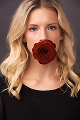 Image showing Woman, face and rose in portrait, studio and floral aesthetic by backdrop or cosmetology. Female person, organic skincare and sustainable fashion or flower for romance, beauty and valentines day