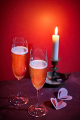 Image showing two glasses of champagne and a burning candle