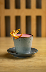 Image showing Strawberry latte with orange peel