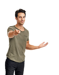 Image showing Happy, pointing and portrait of man in a studio for direction, option or choice expression with confidence. Smile, fashion and handsome young male model with a show hand gesture by white background.