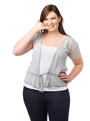 Image showing Portrait, call me hand gesture and a plus size woman in studio isolated on a white background for communication. Smile, finger phone and a happy young person feeling body positive while flirting