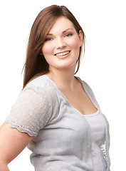 Image showing Portrait, smile and fashion with a plus size woman in studio isolated on a white background for style. Face, happy and clothes with a trendy young body positive model in a casual clothing outfit