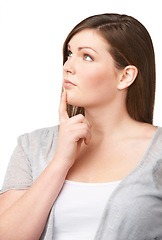 Image showing Face, vision and future with a woman and thinking in studio isolated on white background for planning. Plus size, problem solving and brainstorming with a young body positive model looking thoughtful