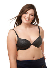 Image showing Portrait, smile and bra with a plus size woman in studio isolated on a white background for body positivity. Beauty, wind and a happy young model looking natural or confident in her underwear