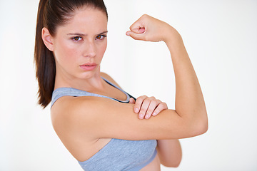 Image showing Woman, portrait or serious in studio with flex for fitness, wellness or workout strength and sportswear. Person, athlete or pride for biceps, exercise or training on white background or mock up space