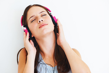 Image showing Woman, peace and listening to music on headphones to relax with sound in white background of studio. Radio, podcast or person streaming a jazz, album or hear audio of song playing with technology