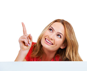 Image showing Woman, poster and pointing at information for communication in studio, announcement or peeking on white background. Female person, billboard placard as mockup for promotion, advertising or signage