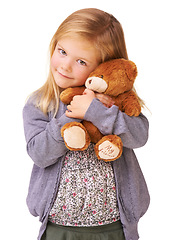 Image showing Portrait, hug and girl with teddy bear, kid and happy isolated on a white studio background. Face, person and model with a toy, embrace and childhood development with joy, play and comfort with care