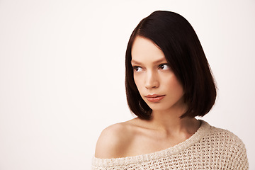 Image showing Thinking, sweater and face of woman on a white background for fashion, winter style and trendy clothes. Confidence, natural beauty and person with shoulder jersey for cozy, comfort and warm in studio