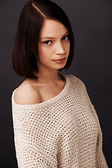 Image showing Fashion, sweater and portrait of woman on black background for beauty, winter style and trendy clothes. Confidence, shoulder and face of natural person with jersey for cozy, comfort or warm in studio