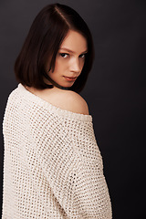 Image showing Shoulder, jersey and portrait of woman on dark background for fashion, winter style and trendy clothes. Confidence, beauty and face of natural person with sweater for cozy, comfort and warm in studio