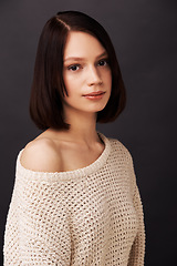 Image showing Fashion, jersey and portrait of woman on gray background for natural beauty, winter style and trendy clothes. Model, shoulder and face of person with sweater for cozy, comfort and warm in studio